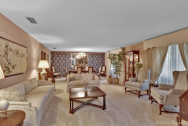 living room with light carpet and a chandelier