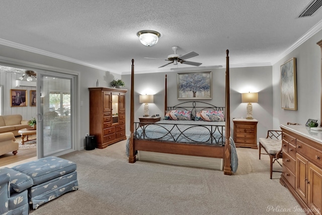 bedroom featuring crown molding, ceiling fan, light carpet, and a textured ceiling