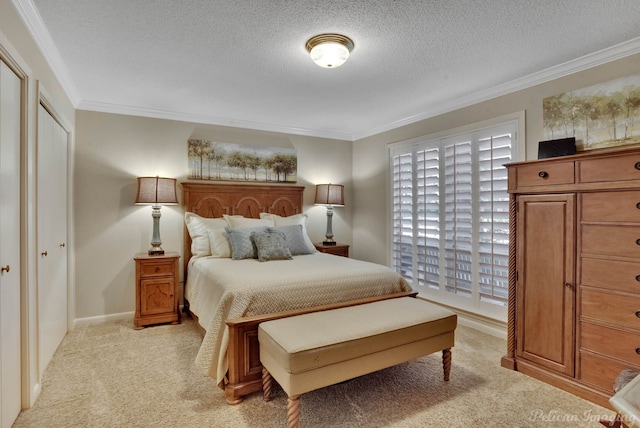 bedroom featuring a closet, light colored carpet, a textured ceiling, and ornamental molding