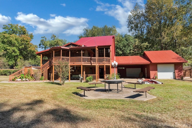 back of house with a yard, a deck, a garage, and a patio area