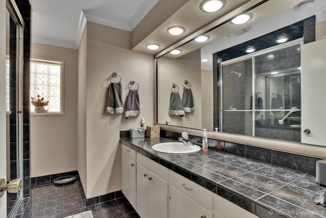 bathroom with tile patterned floors, vanity, an enclosed shower, and crown molding