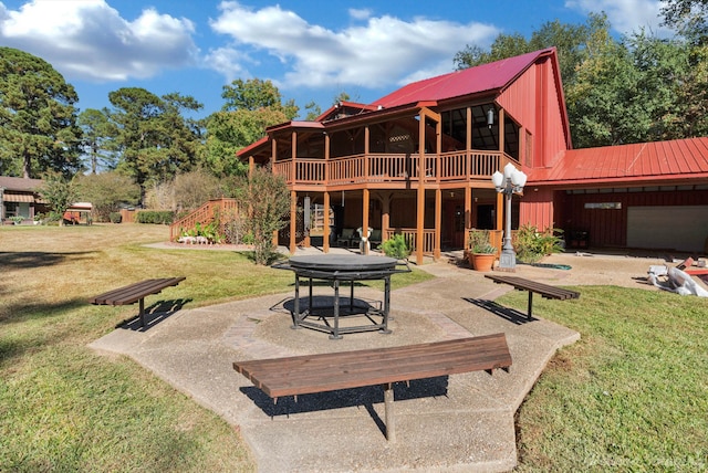 rear view of house featuring a patio area, a yard, and a wooden deck