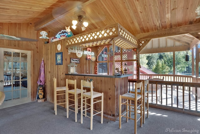 bar with vaulted ceiling with beams, wood ceiling, carpet floors, and wooden walls