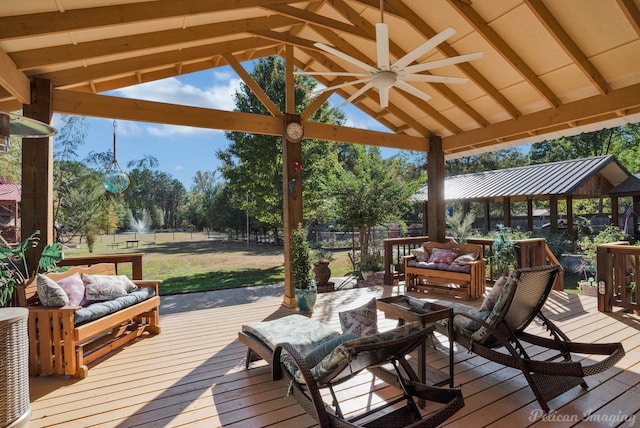 wooden deck featuring a gazebo, outdoor lounge area, and ceiling fan