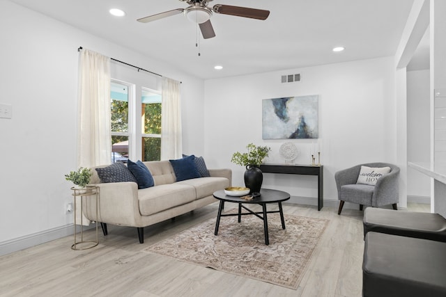 living room featuring light hardwood / wood-style flooring and ceiling fan