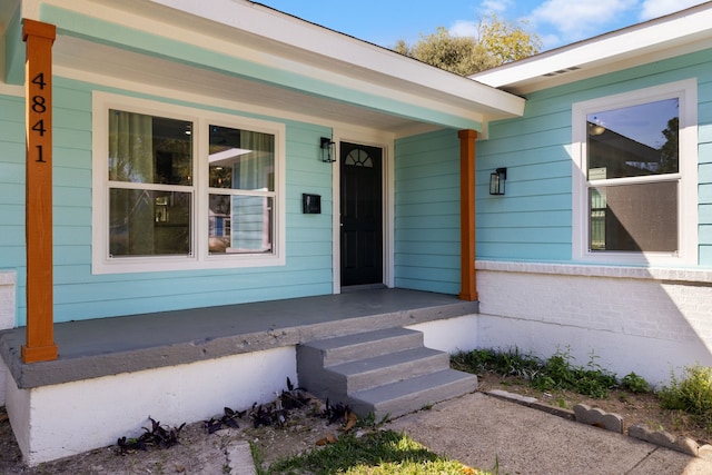 doorway to property with a porch