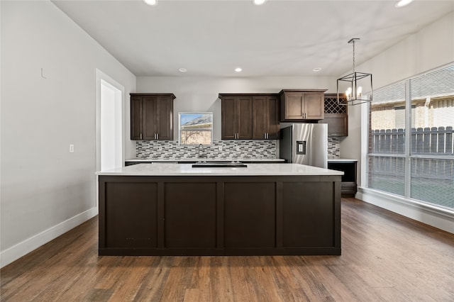 kitchen featuring stainless steel fridge with ice dispenser, dark hardwood / wood-style floors, and plenty of natural light