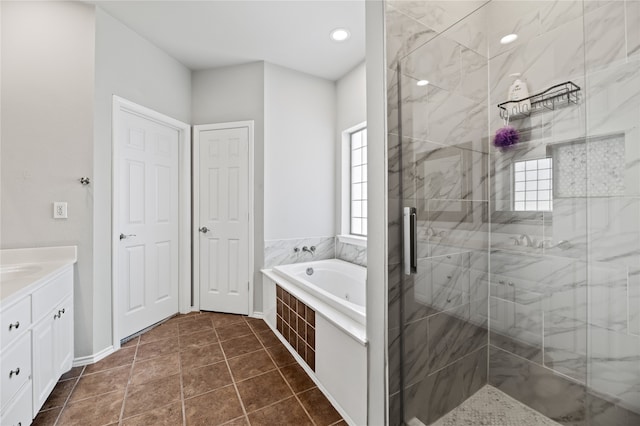 bathroom with vanity, independent shower and bath, and tile patterned flooring