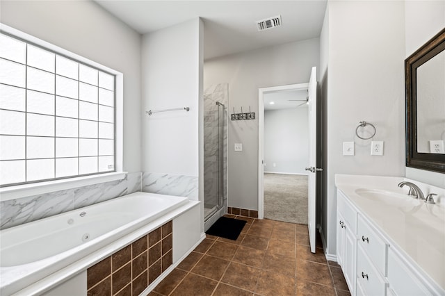 bathroom featuring vanity, shower with separate bathtub, and tile patterned floors