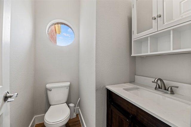 bathroom featuring toilet and vanity