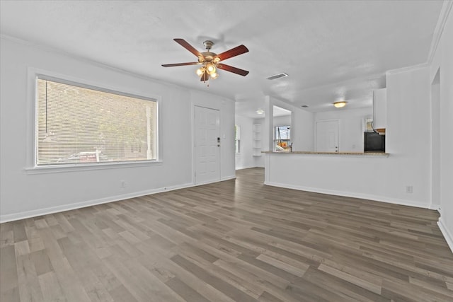 unfurnished living room with crown molding, hardwood / wood-style floors, and ceiling fan