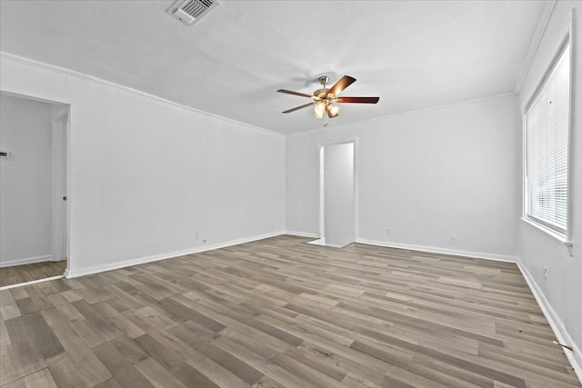 spare room with ceiling fan, hardwood / wood-style flooring, ornamental molding, and a textured ceiling