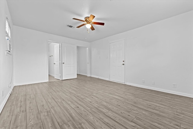 empty room with light hardwood / wood-style flooring and ceiling fan