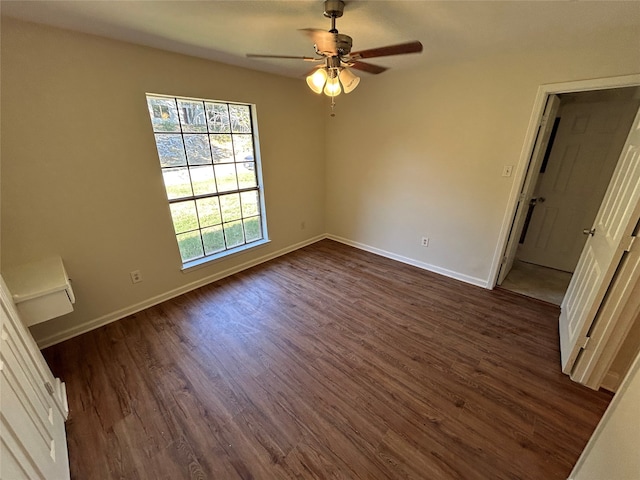 interior space with dark wood-type flooring and ceiling fan