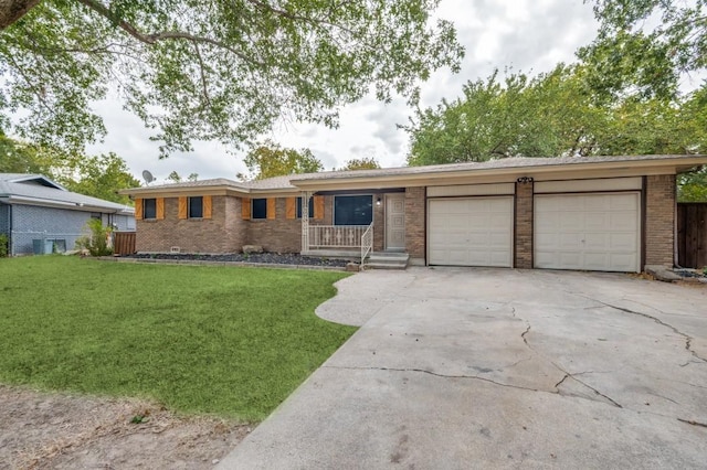 ranch-style home featuring a garage and a front yard