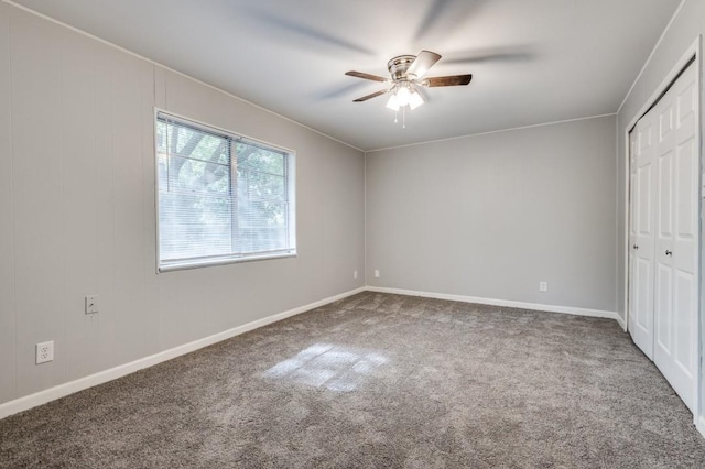 unfurnished bedroom with ceiling fan, a closet, and carpet