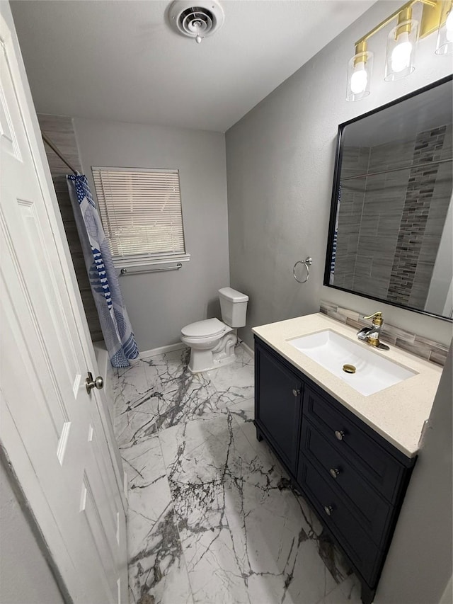 bathroom featuring toilet, vanity, and a shower with shower curtain