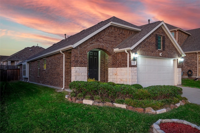 2418 San Marcos Dr, Forney, TX 75126 - exterior space with roof with shingles, concrete driveway, brick siding, an attached garage, and a yard