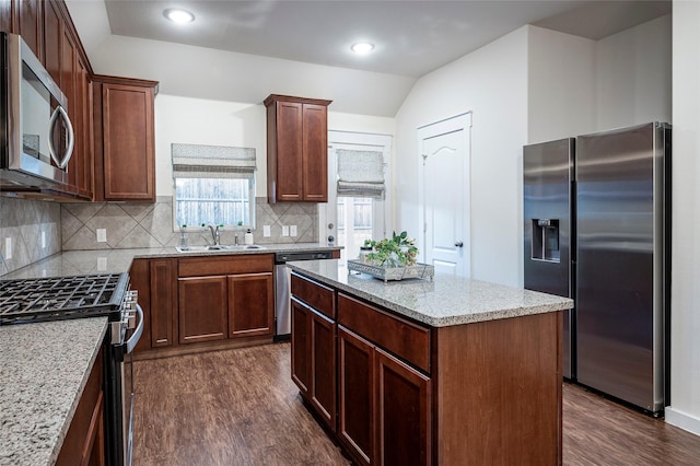 2418 San Marcos Dr, Forney, TX 75126 - kitchen with stainless steel appliances, a sink, vaulted ceiling, backsplash, and dark wood-type flooring