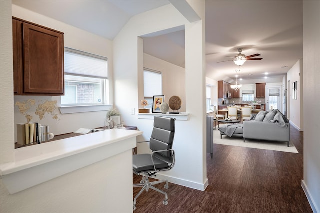 office featuring ceiling fan with notable chandelier, dark hardwood / wood-style floors, and lofted ceiling