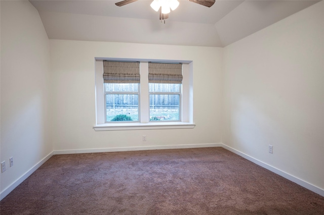 empty room with ceiling fan, carpet flooring, and vaulted ceiling