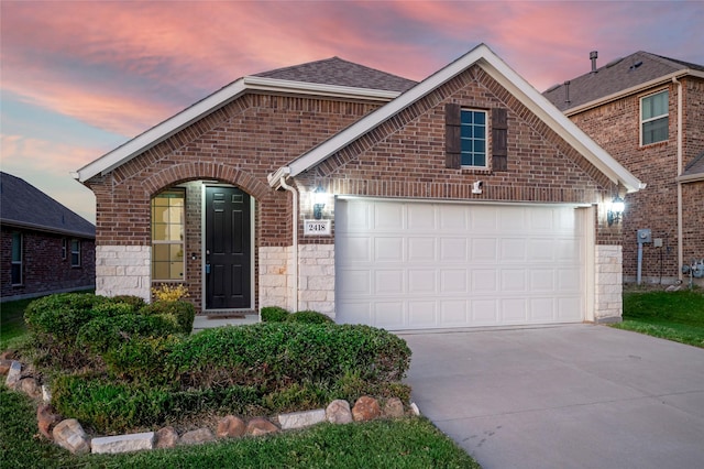 2418 San Marcos Dr, Forney, TX 75126 - view of front of property with brick siding, a shingled roof, a garage, and concrete driveway