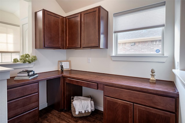 office space featuring built in desk, dark hardwood / wood-style floors, and lofted ceiling