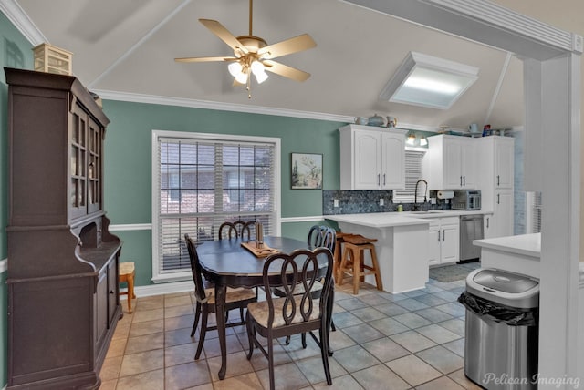 dining room with light tile patterned floors, ceiling fan, ornamental molding, and sink