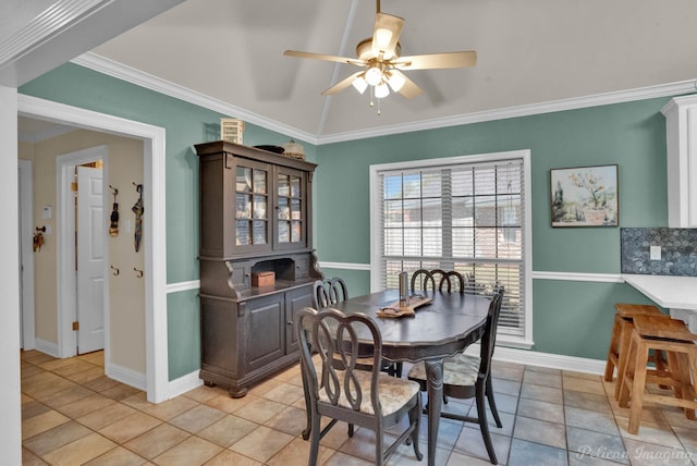 tiled dining area featuring ceiling fan and ornamental molding