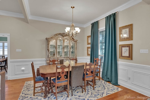 dining area with a chandelier, light hardwood / wood-style flooring, and ornamental molding