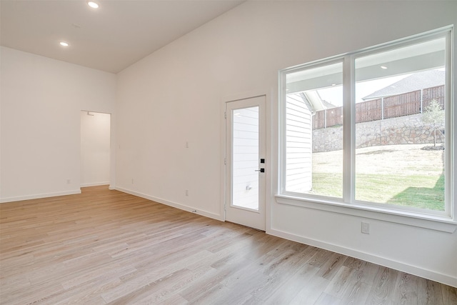 interior space featuring light hardwood / wood-style flooring and vaulted ceiling