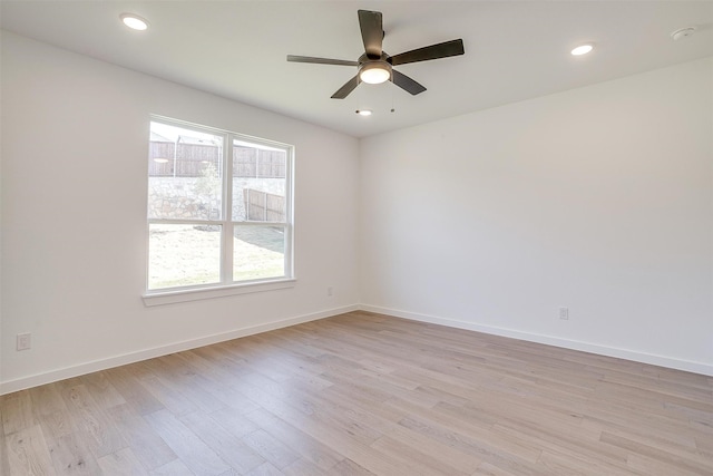 spare room with light hardwood / wood-style flooring, plenty of natural light, and ceiling fan