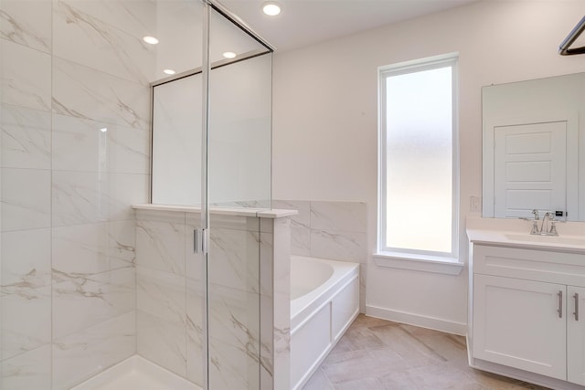 bathroom with vanity and separate shower and tub