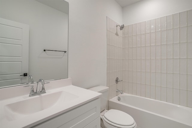 full bathroom featuring vanity, tiled shower / bath combo, and toilet