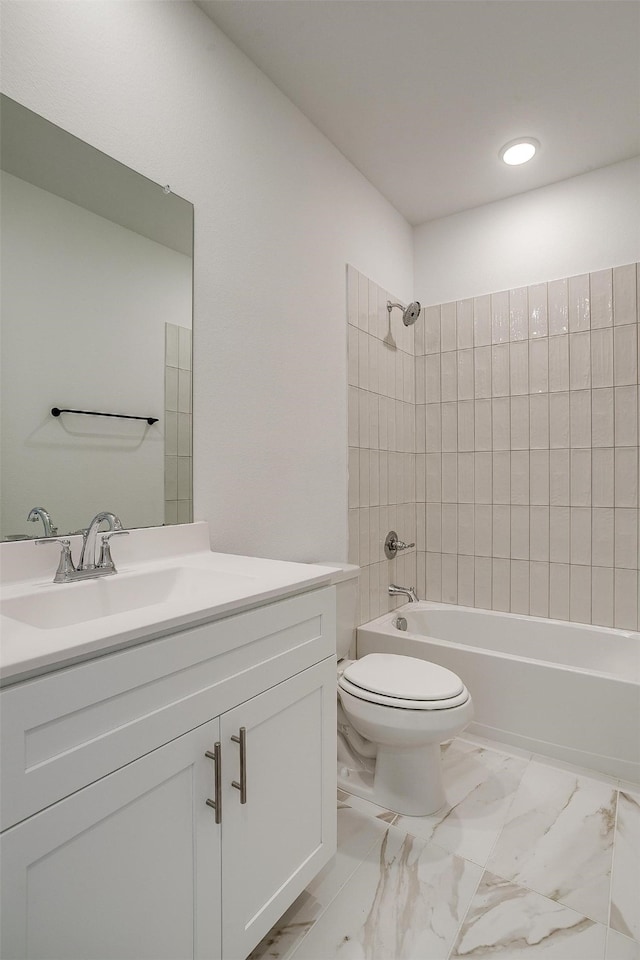 full bathroom featuring vanity, toilet, and tiled shower / bath