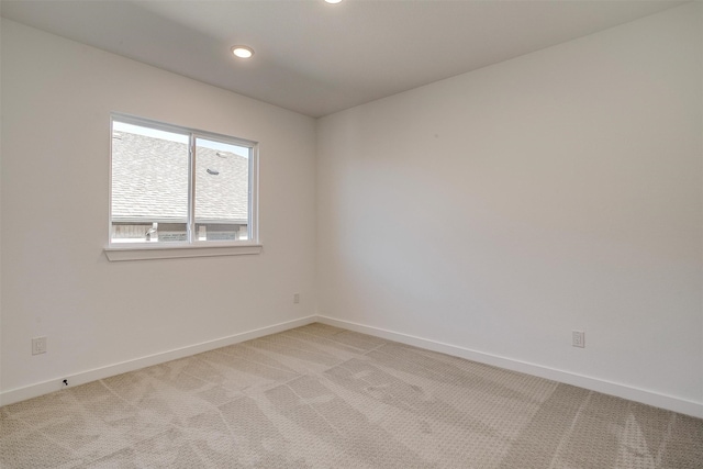 unfurnished room featuring light colored carpet