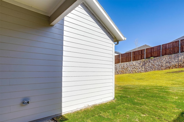 view of side of property with a lawn