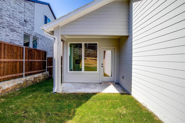 doorway to property featuring a yard