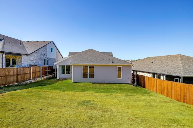 back of house with a lawn