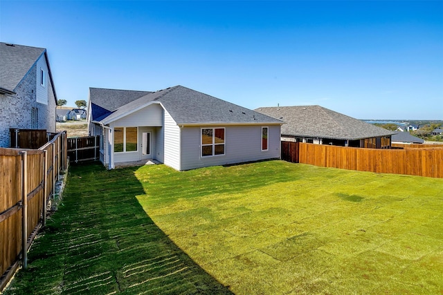 rear view of property with a yard