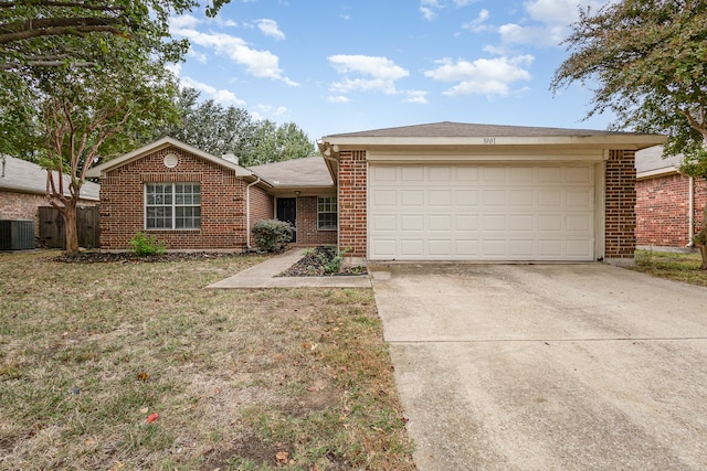 single story home featuring cooling unit, a front yard, and a garage