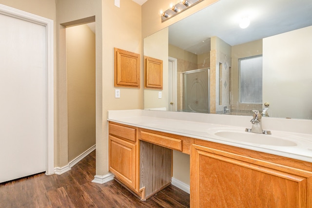 bathroom featuring vanity, an enclosed shower, and hardwood / wood-style flooring