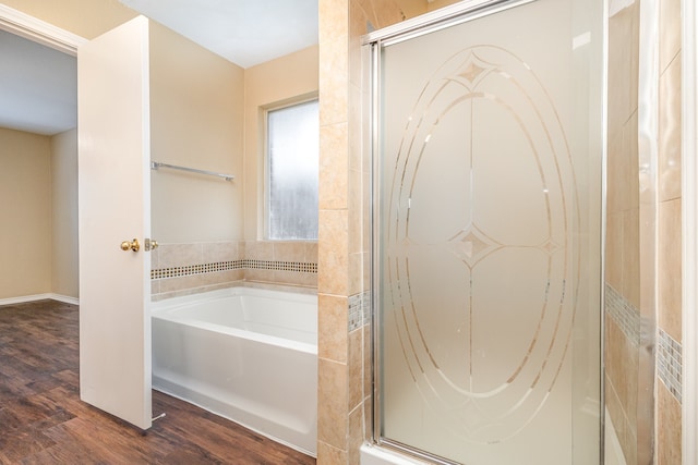 bathroom with plus walk in shower and wood-type flooring