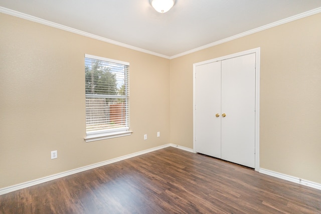 unfurnished bedroom featuring a closet, crown molding, and dark hardwood / wood-style flooring