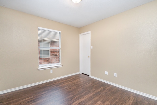 spare room with dark hardwood / wood-style floors