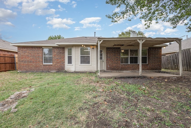 rear view of house featuring a patio area and a lawn