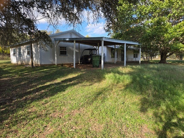 rear view of house featuring a yard