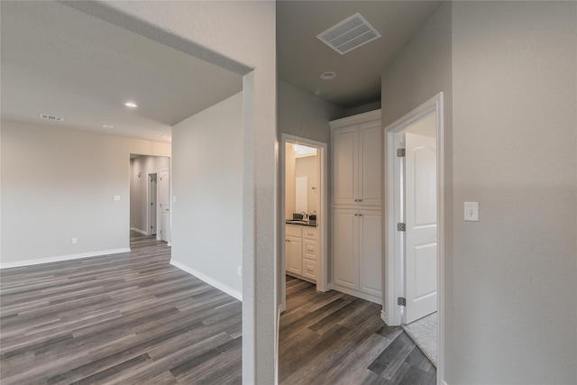 corridor featuring dark wood-type flooring