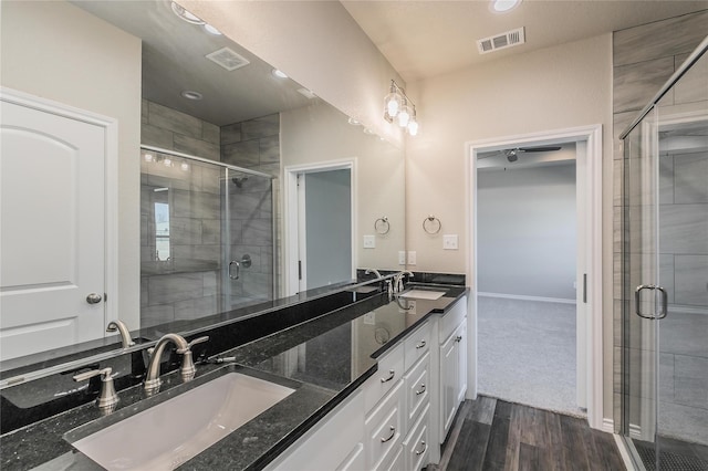 bathroom with vanity, hardwood / wood-style floors, and an enclosed shower