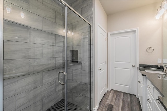 bathroom with vanity, hardwood / wood-style floors, and walk in shower